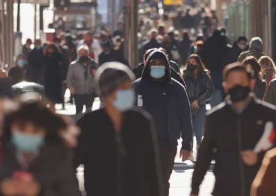 crowd of people in masks on high street during a virus outbreak